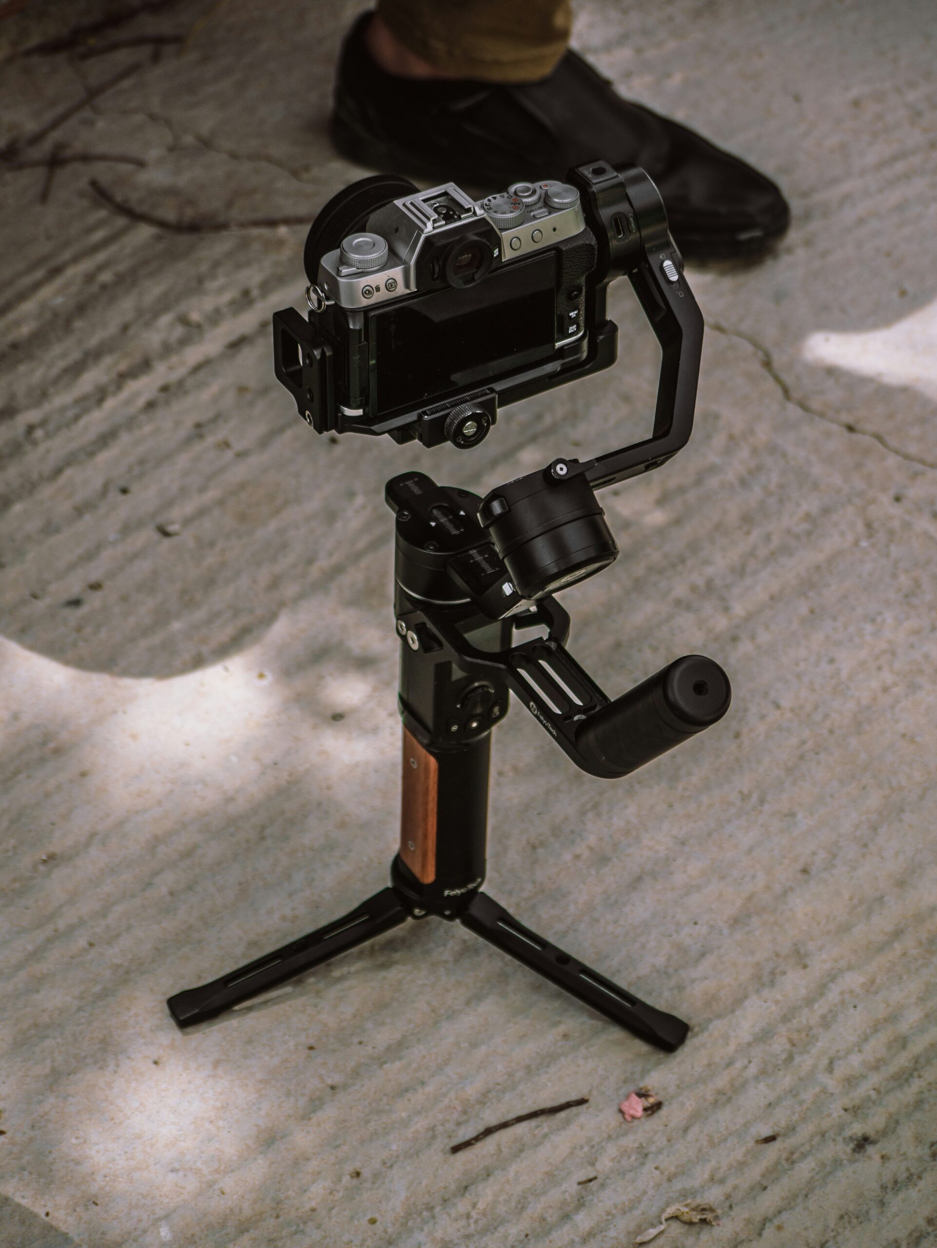 Camera support setup for filmmakers using a tripod and stabilizing gear on set